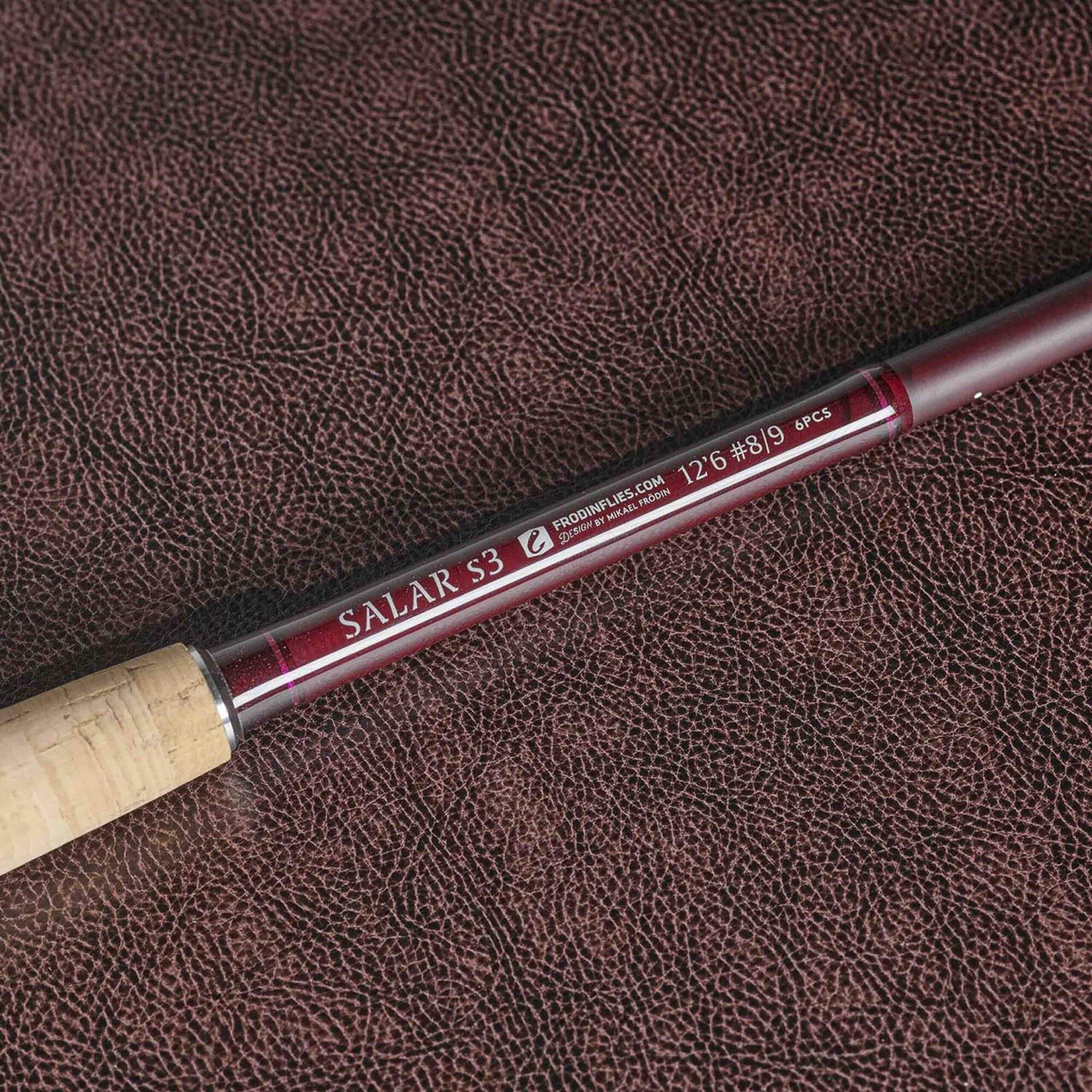 Frodin Salar s3 dh fly rods detail shot of the rod logo on burgundy leather background