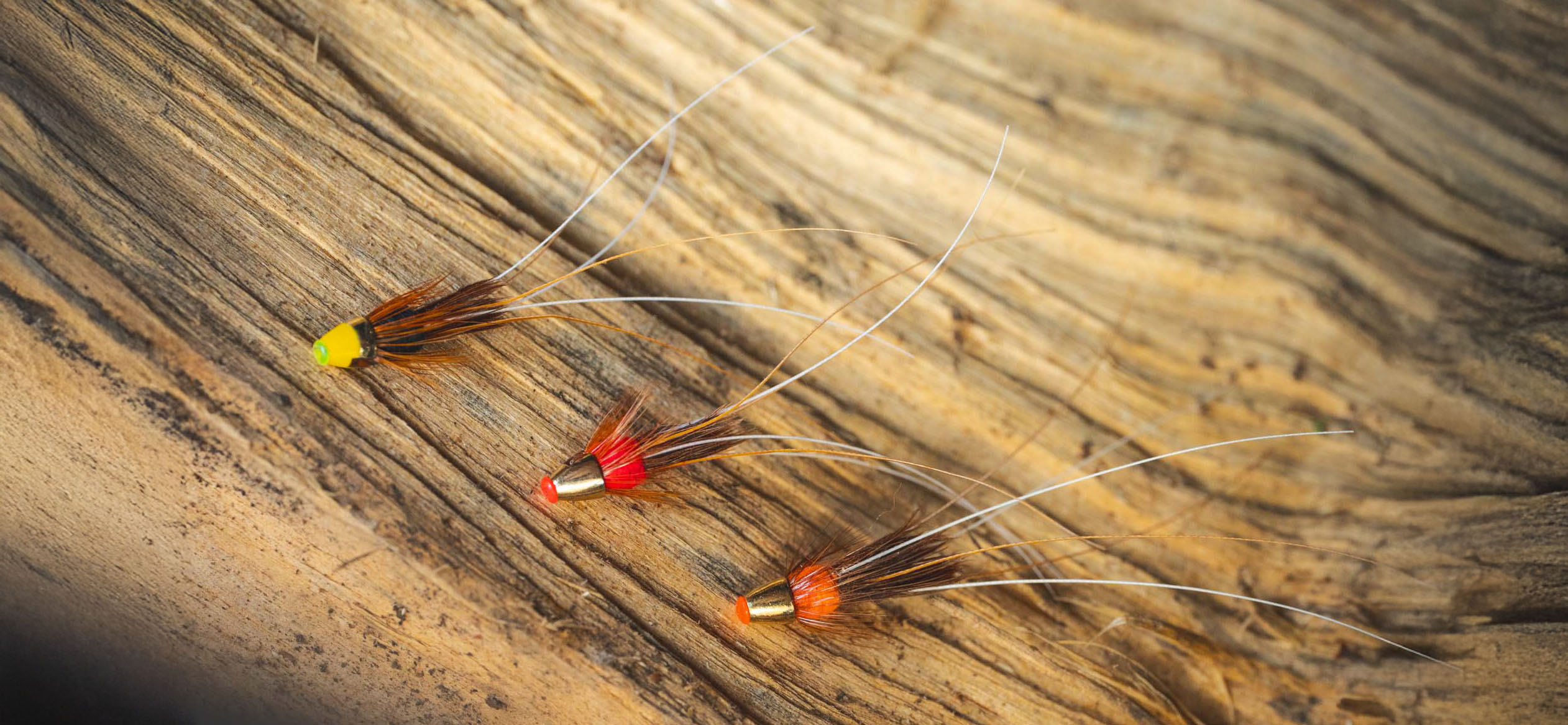 DSC00282 A range of Tungsten Conehead Frances Flies on side of a salmon river